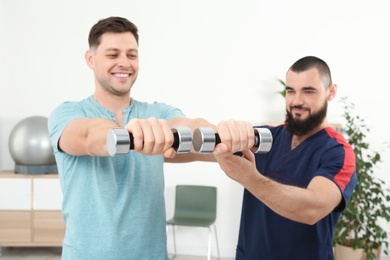 Physiotherapist working with patient in clinic. Rehabilitation therapy