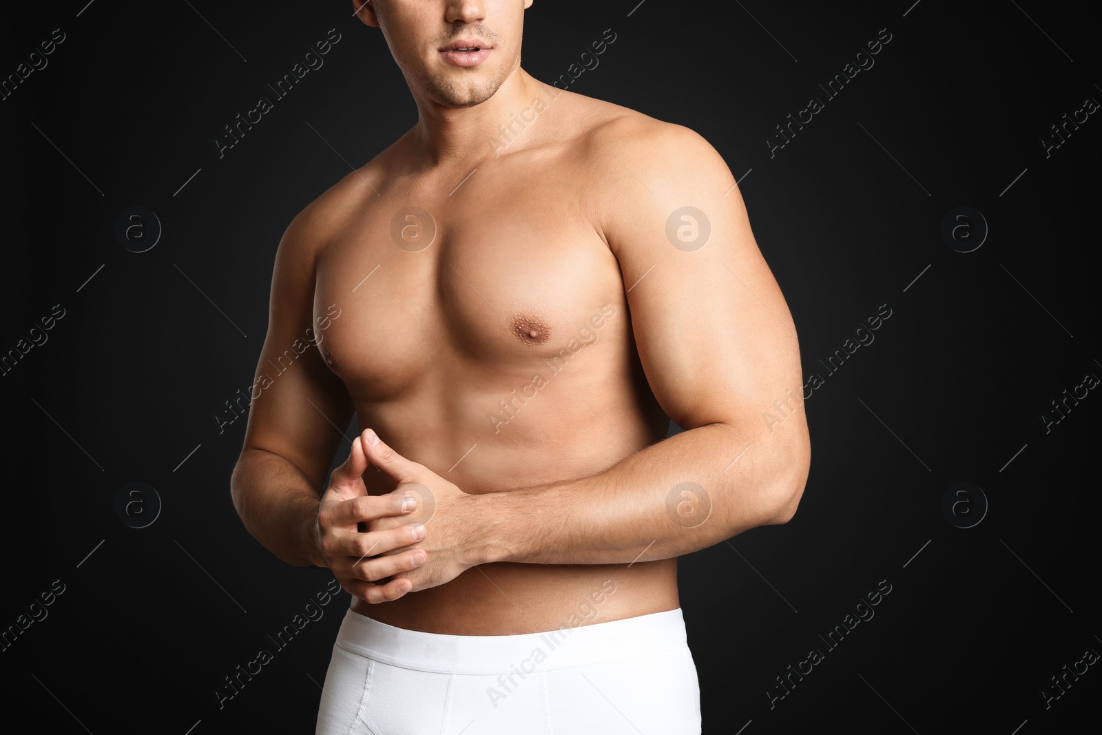 Photo of Man with sexy body on grey background, closeup