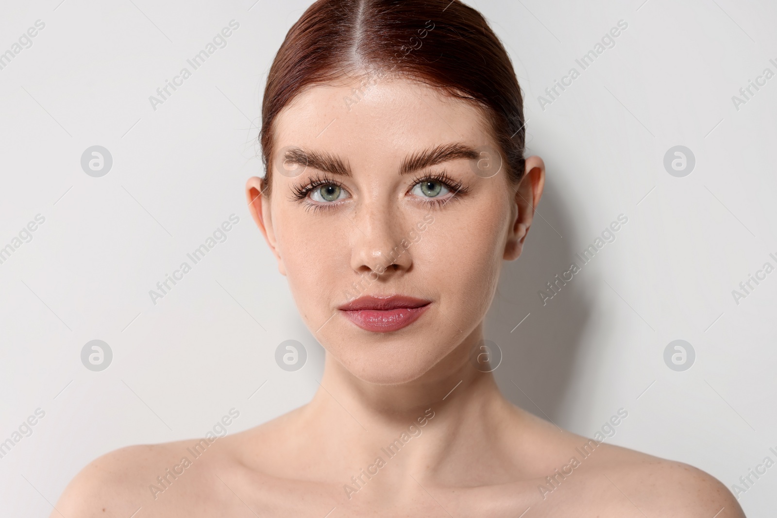 Photo of Portrait of beautiful woman on light background, closeup