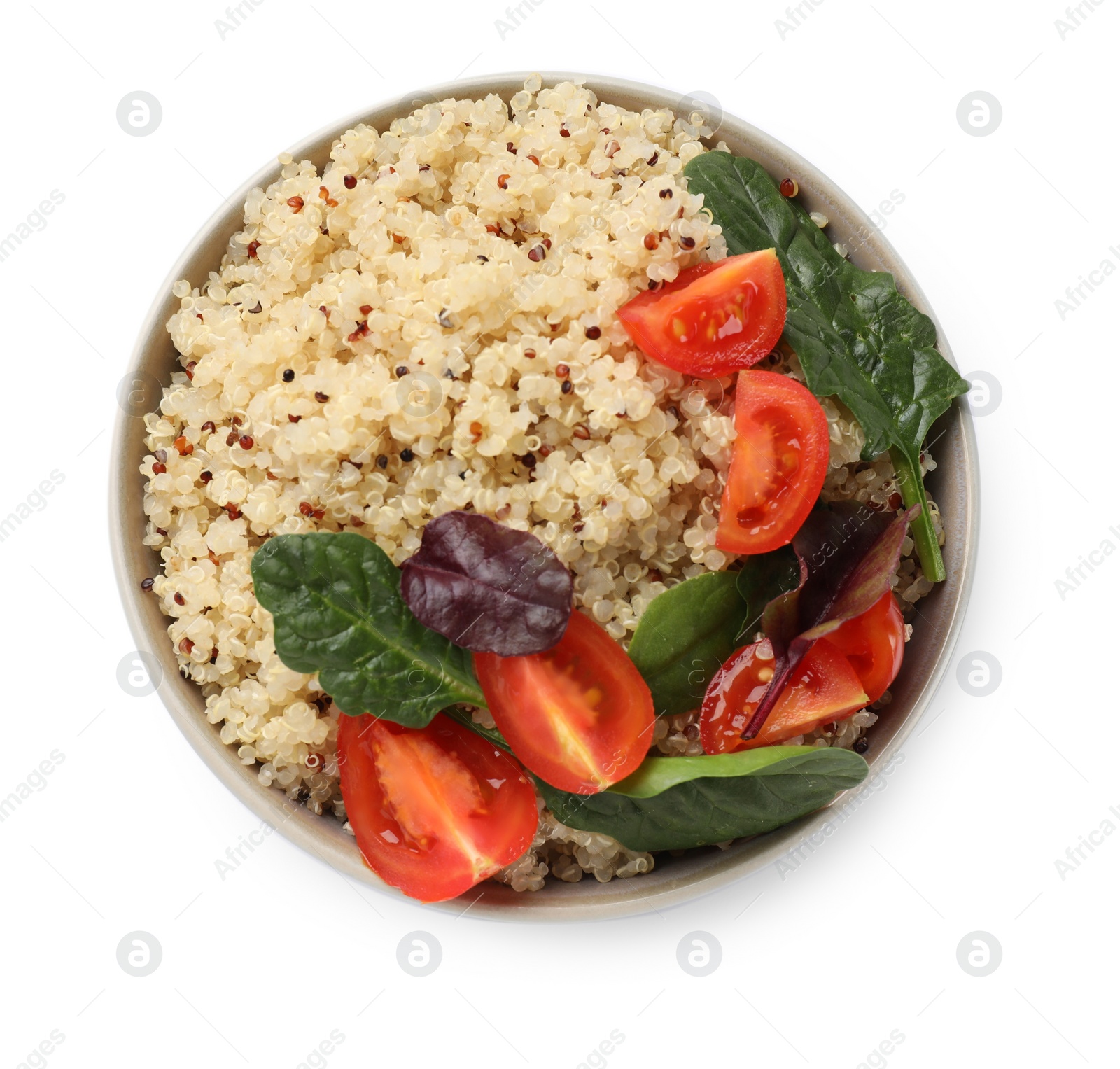 Photo of Tasty quinoa porridge with tomatoes and spinach in bowl isolated on white, top view