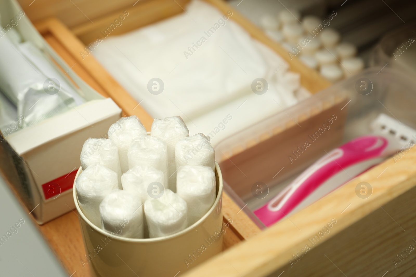 Photo of Storage of different feminine hygiene products in drawer, closeup