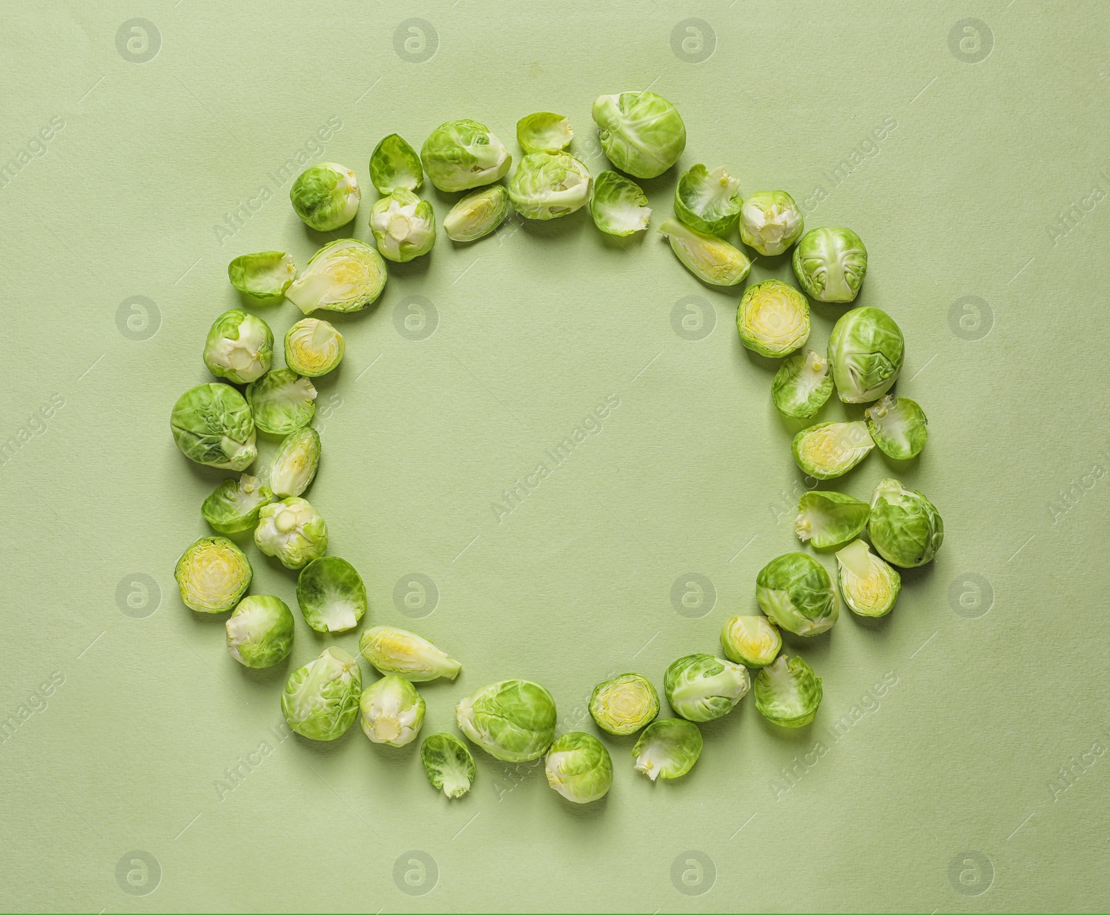 Photo of Frame made with Brussels sprouts on color background, top view. Space for text