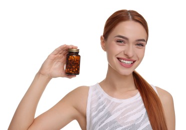 Happy young woman with bottle of pills on white background. Weight loss