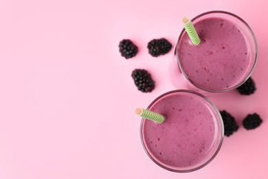 Photo of Delicious blackberry smoothie on pink background, flat lay. Space for text