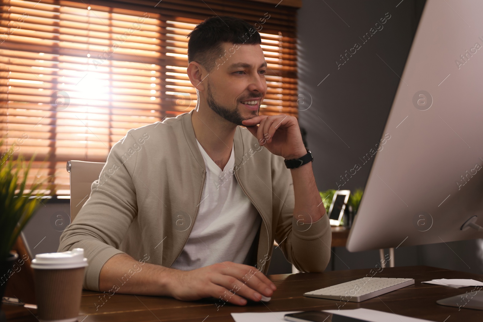 Photo of Freelancer working on computer at table indoors