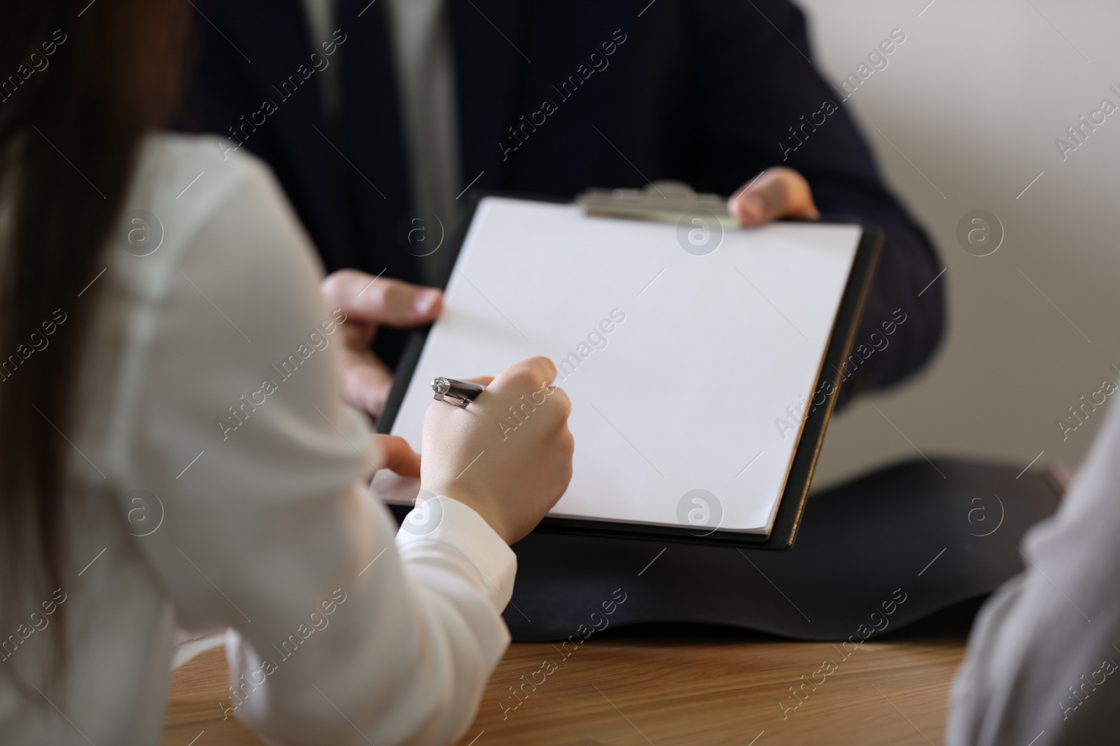 Photo of Male lawyer working with clients in office, closeup