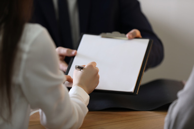 Male lawyer working with clients in office, closeup