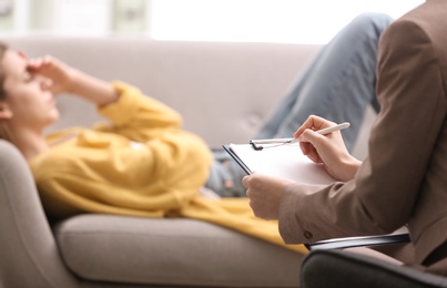 Photo of Psychotherapist working with woman in office, closeup