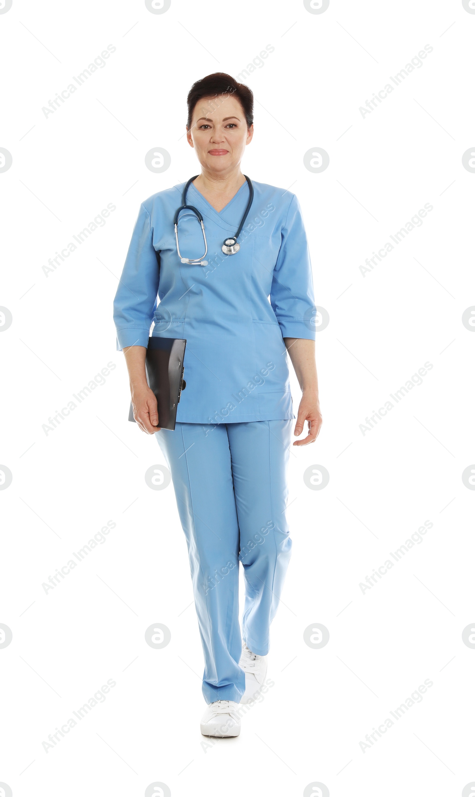 Photo of Full length portrait of female doctor in scrubs with clipboard isolated on white. Medical staff