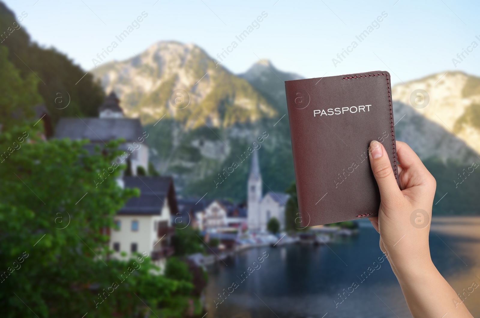 Image of Woman with passport and beautiful view of town near mountains on background