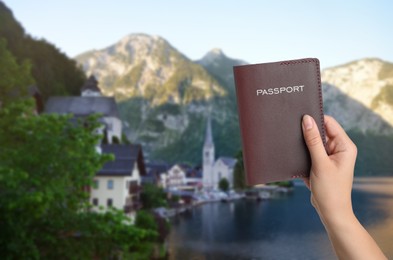 Image of Woman with passport and beautiful view of town near mountains on background