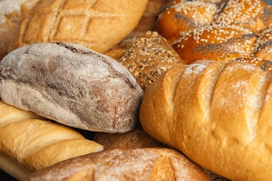 Photo of Loaves of different breads as background, closeup