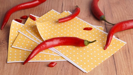 Photo of Pepper plasters and chili on wooden table, closeup