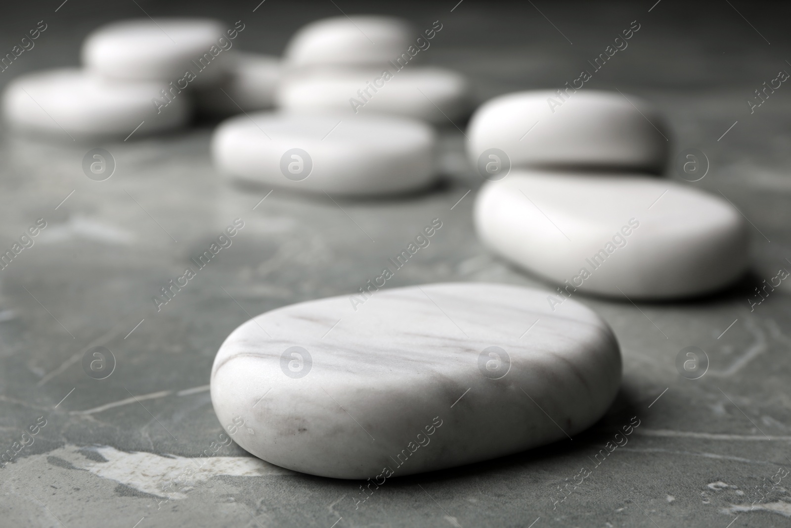 Photo of Spa stones on grey background. Space for text