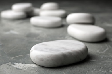 Spa stones on grey background. Space for text