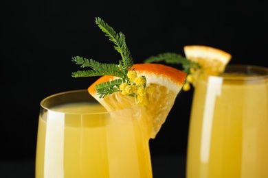 Glass of Mimosa cocktail with garnish, closeup