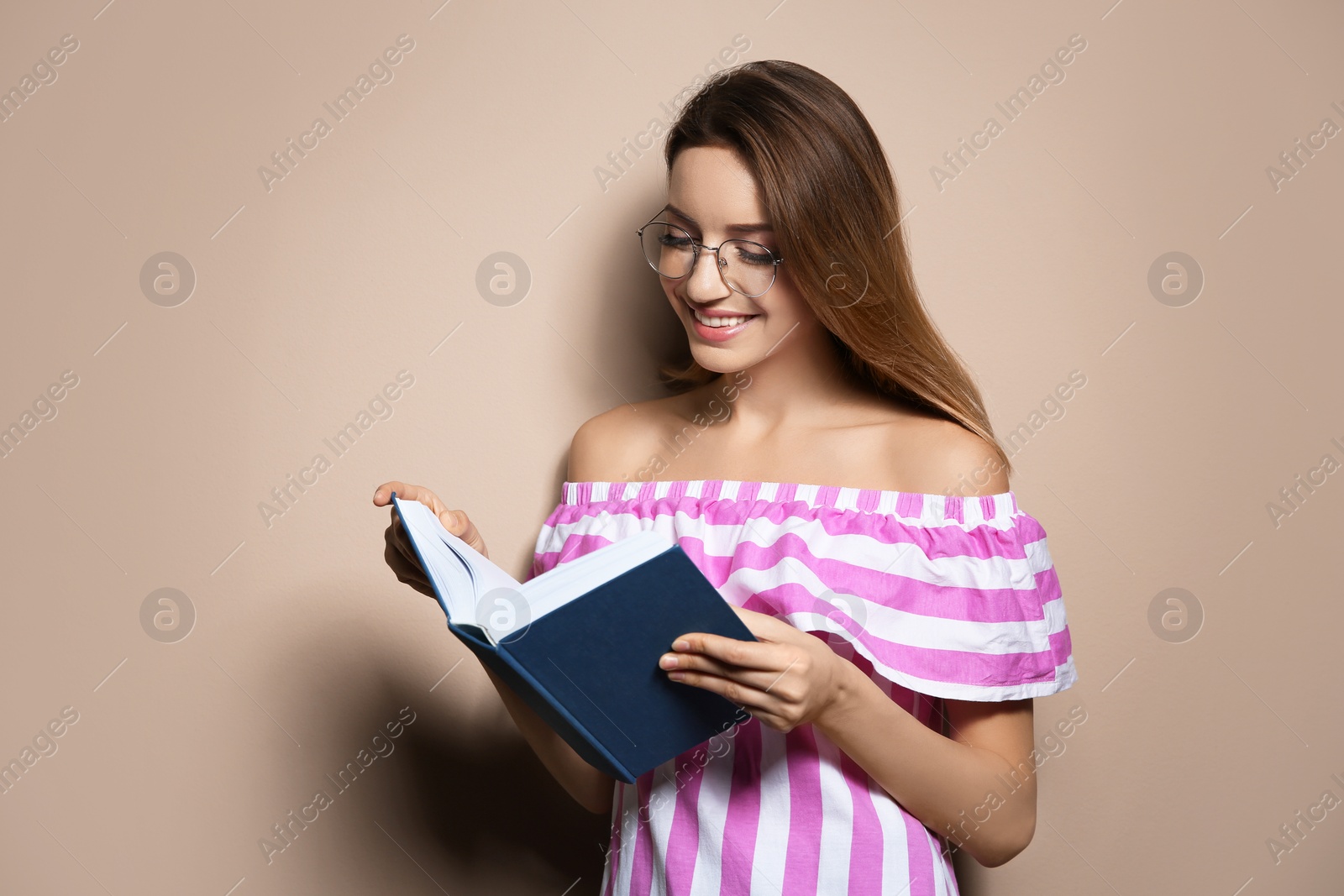 Photo of Young woman with book on color background, space for text