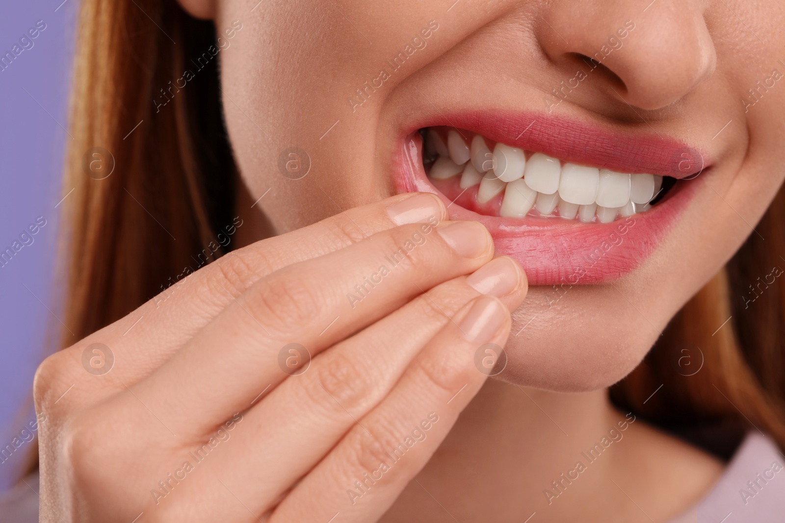 Photo of Woman showing her clean teeth, closeup view