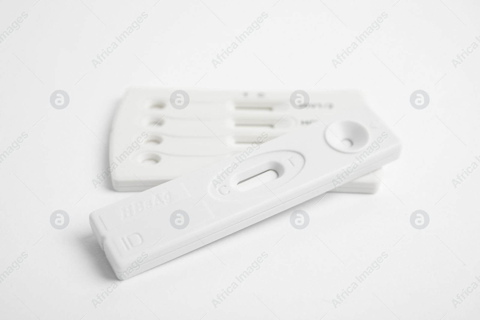 Photo of Two disposable express tests for hepatitis on white background