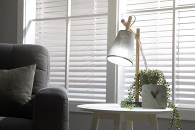 Photo of Room interior with stylish lamp and furniture