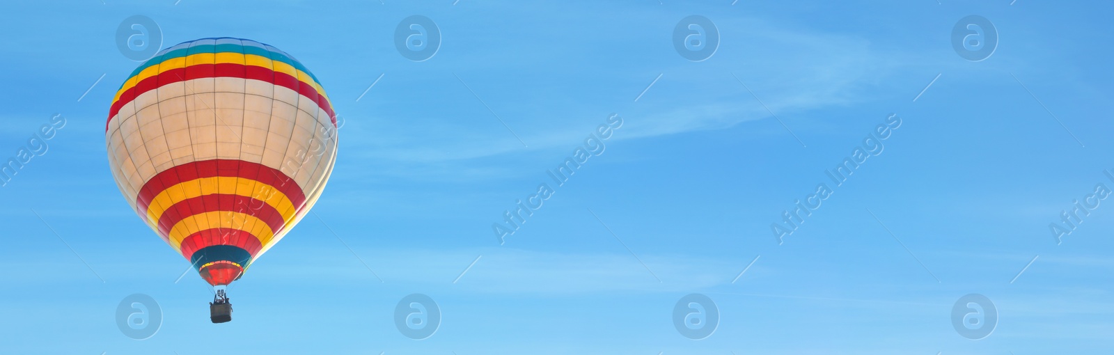 Image of Hot air balloon in blue sky, space for text. Banner design 