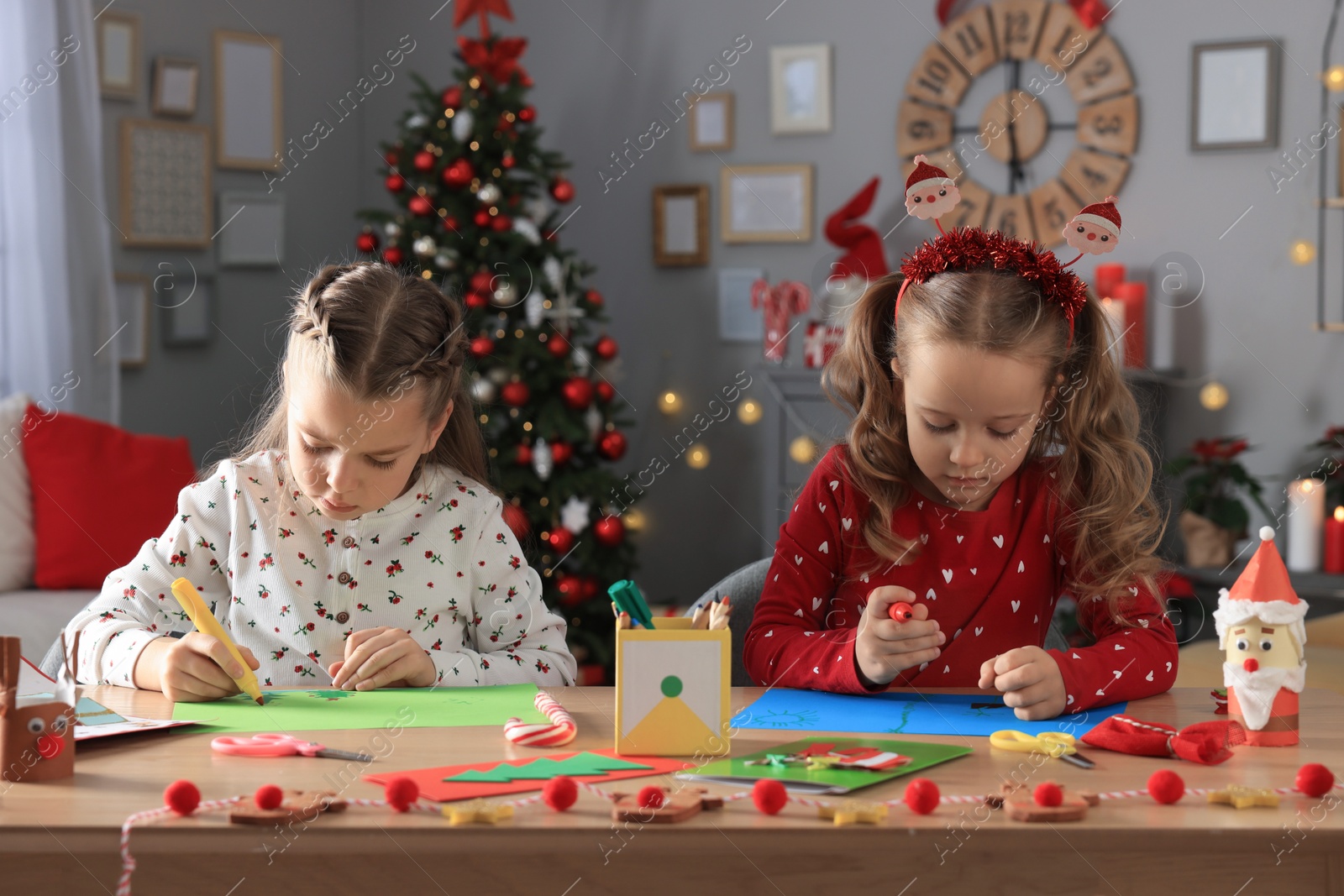 Photo of Cute little children making beautiful Christmas greeting cards at home