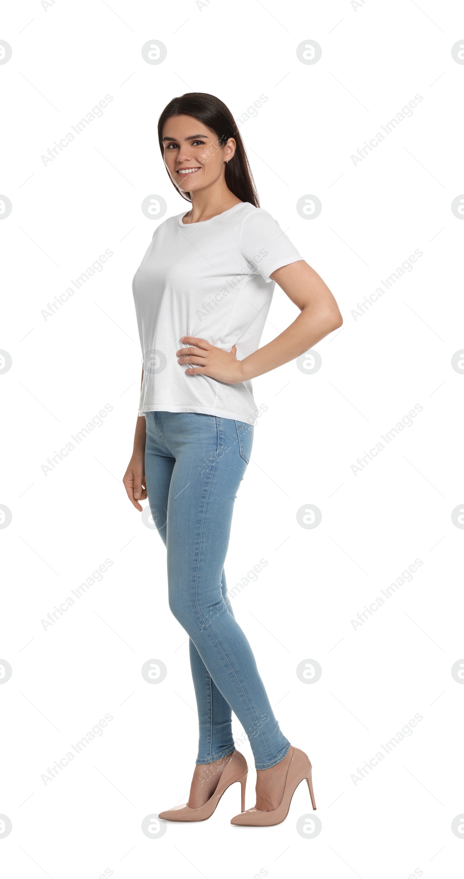 Photo of Happy woman wearing stylish light blue jeans and high heels shoes on white background