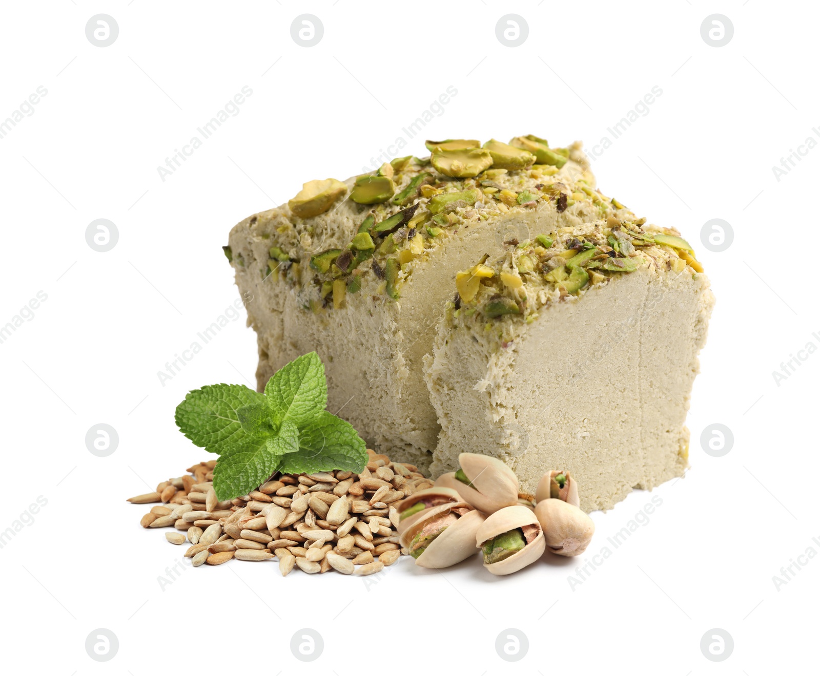 Image of Tasty halva, peeled sunflower seeds, pistachio nuts and mint leaves isolated on white