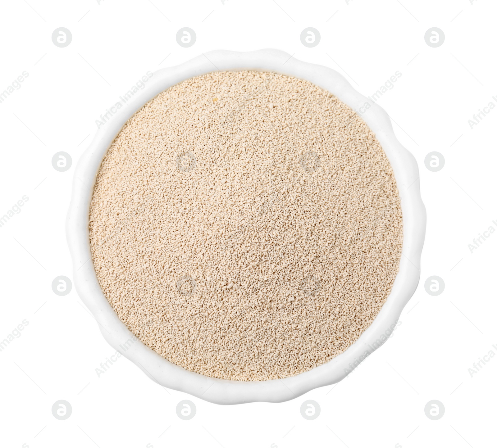 Photo of Granulated yeast in bowl isolated on white, top view