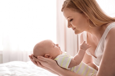 Mother with her little baby in bedroom