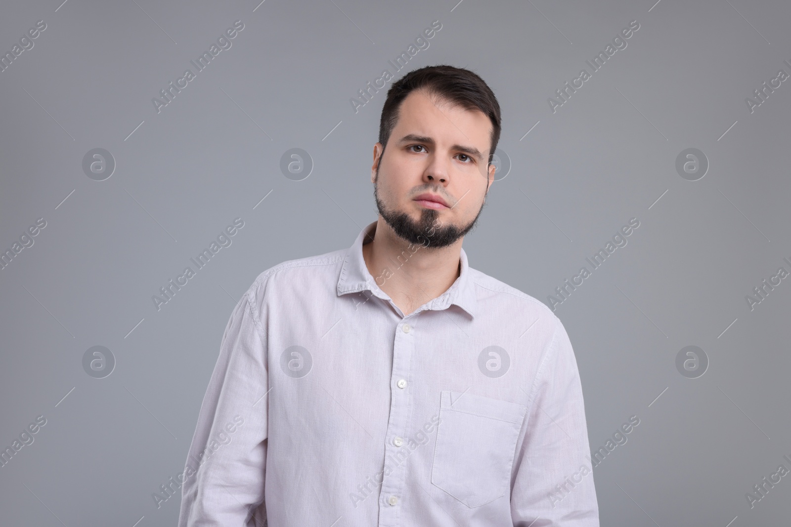 Photo of Portrait of sad man on grey background