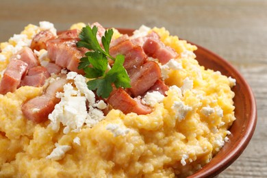 Photo of Delicious traditional Ukrainian banosh in bowl on table, closeup