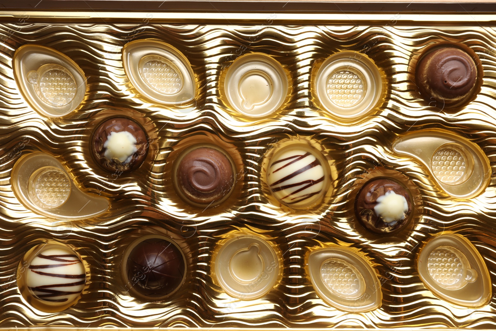 Photo of Partially empty box of chocolate candies as background, top view