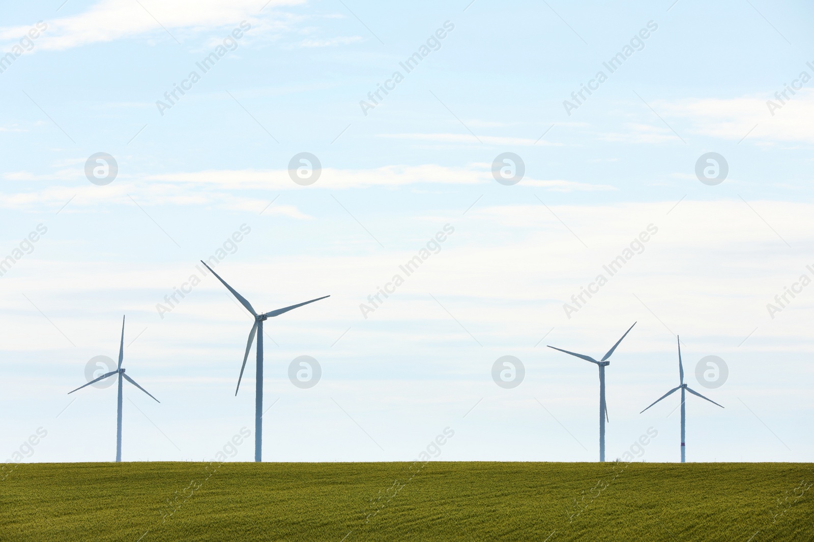 Photo of Beautiful view of field with wind turbines. Alternative energy source