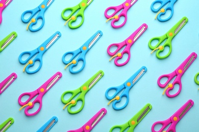 Photo of Set of training scissors on color background, flat lay