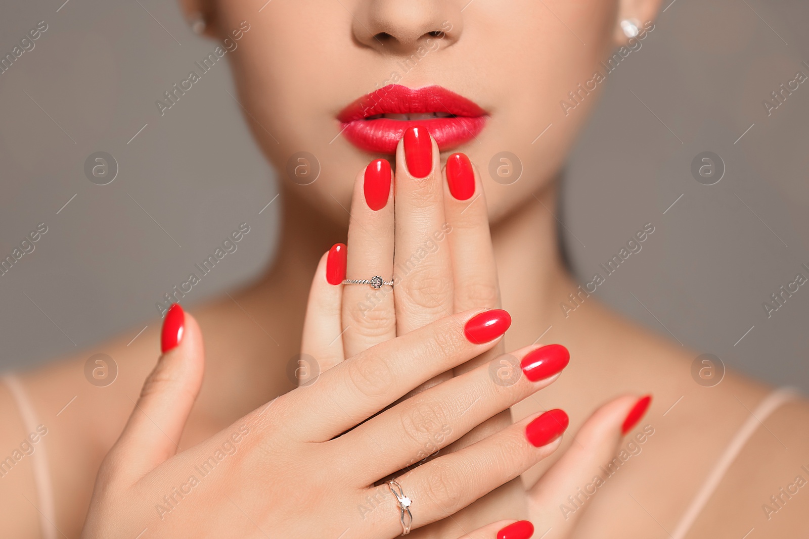 Photo of Beautiful young woman with bright manicure on color background, closeup. Nail polish trends