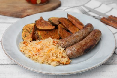 Photo of Plate with sauerkraut, sausages and potatoes on white wooden table, closeup