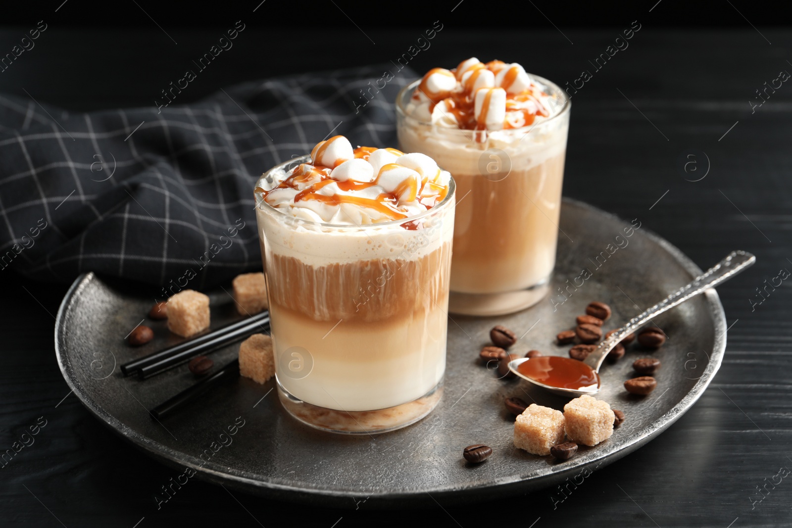 Photo of Glasses with delicious caramel frappe on tray