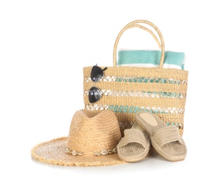 Bag with beach accessories on white background