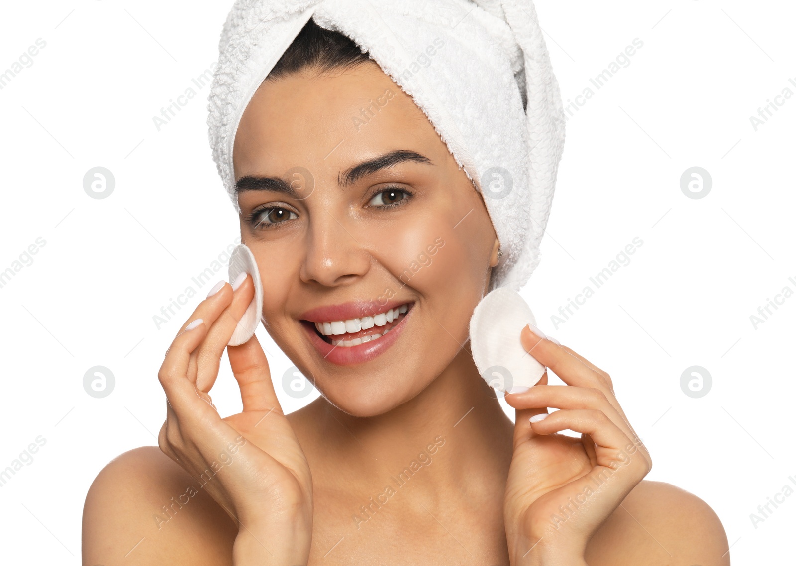 Photo of Young woman using cotton pads with micellar water on white background