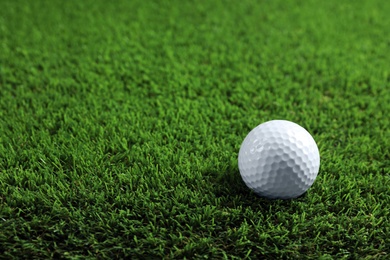 Golf ball on green grass. Space for text