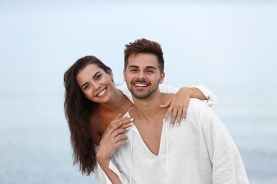 Photo of Happy young couple spending time together on beach