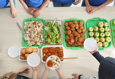 Table with food prepared by volunteers for poor people, top view