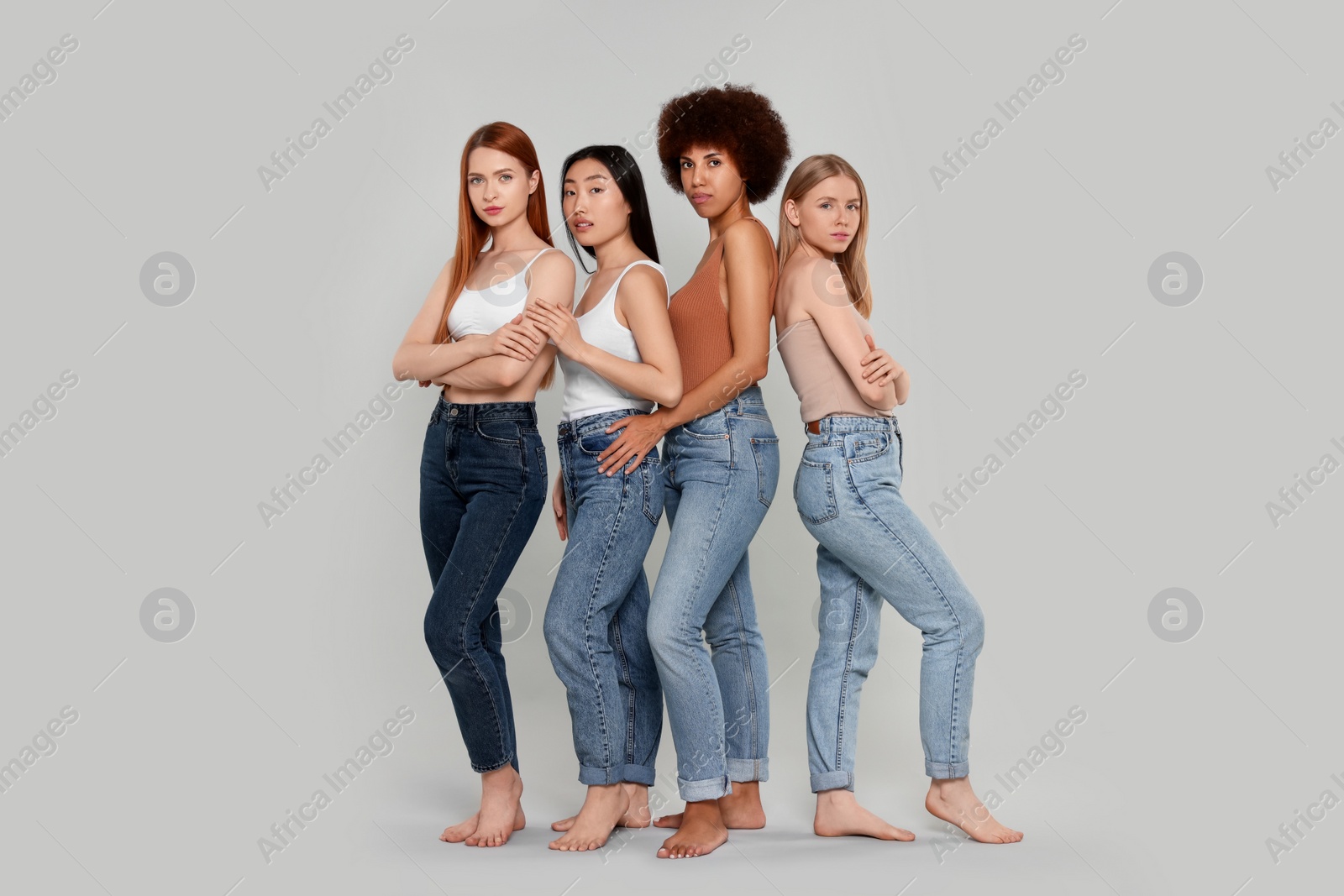 Photo of Group of beautiful young women on light grey background