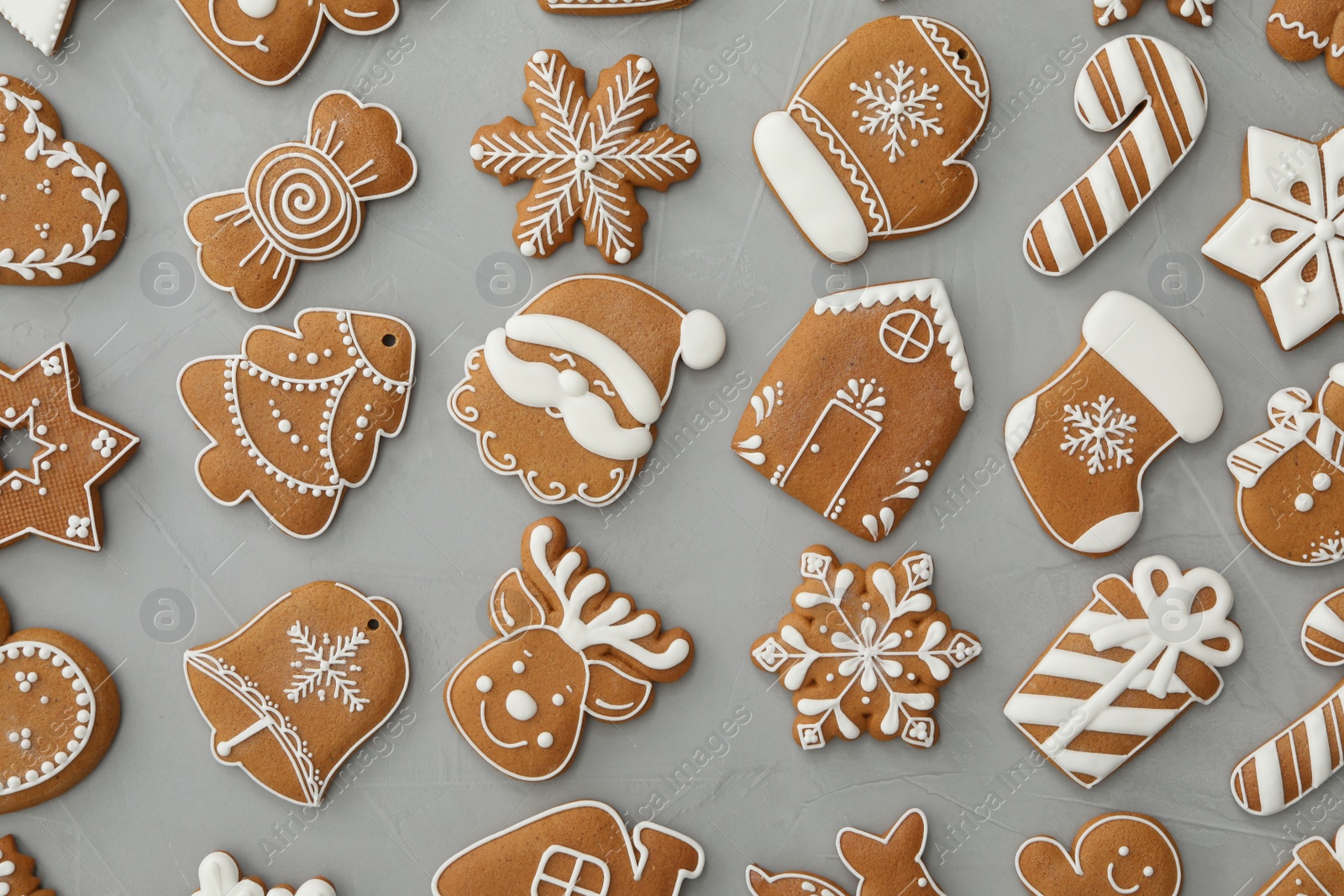 Photo of Different Christmas gingerbread cookies on grey background, flat lay