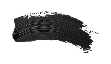 Photo of Brushstroke of black oil paint on white background, top view