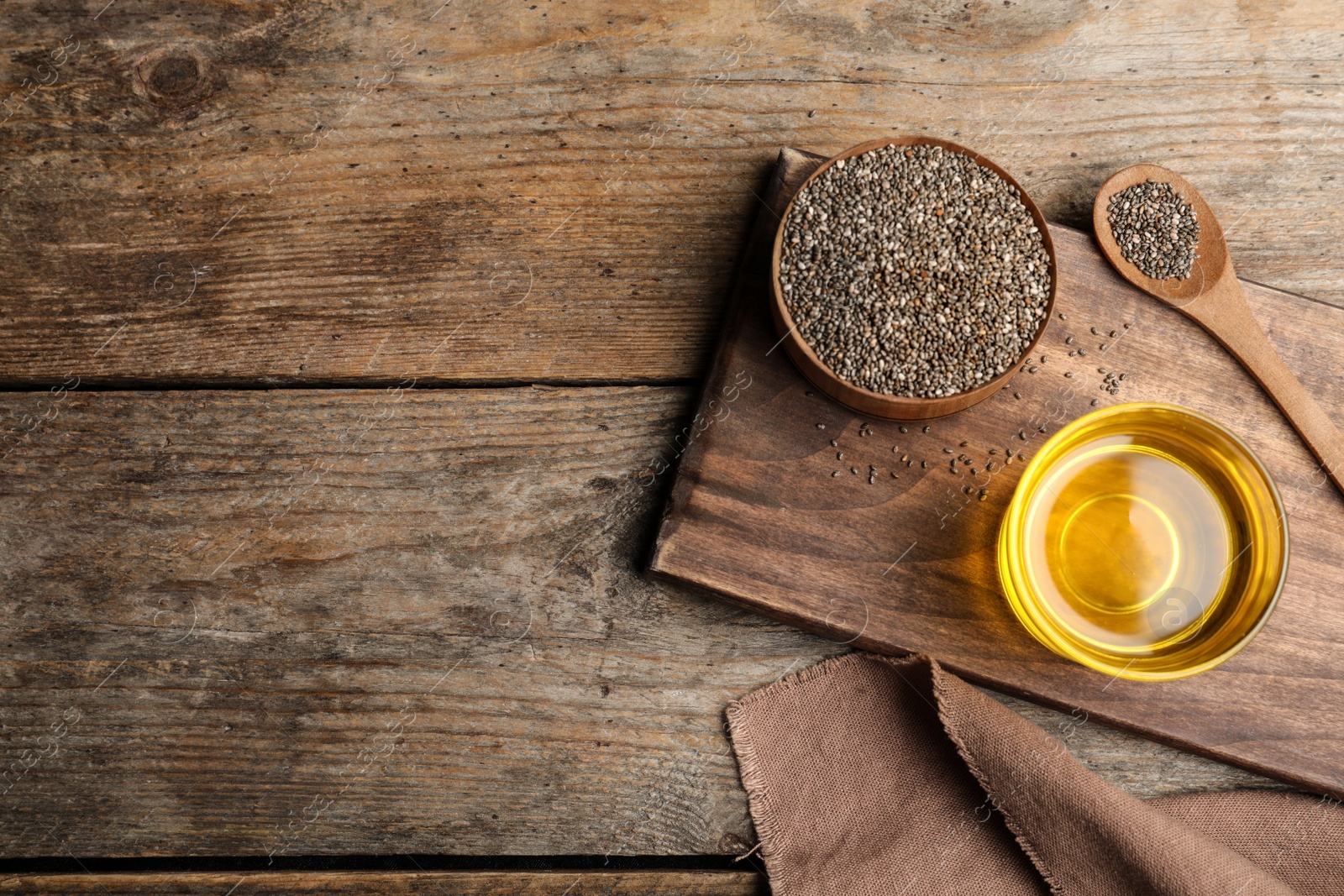 Photo of Flat lay composition with chia seeds oil and grains on wooden table. Space for text