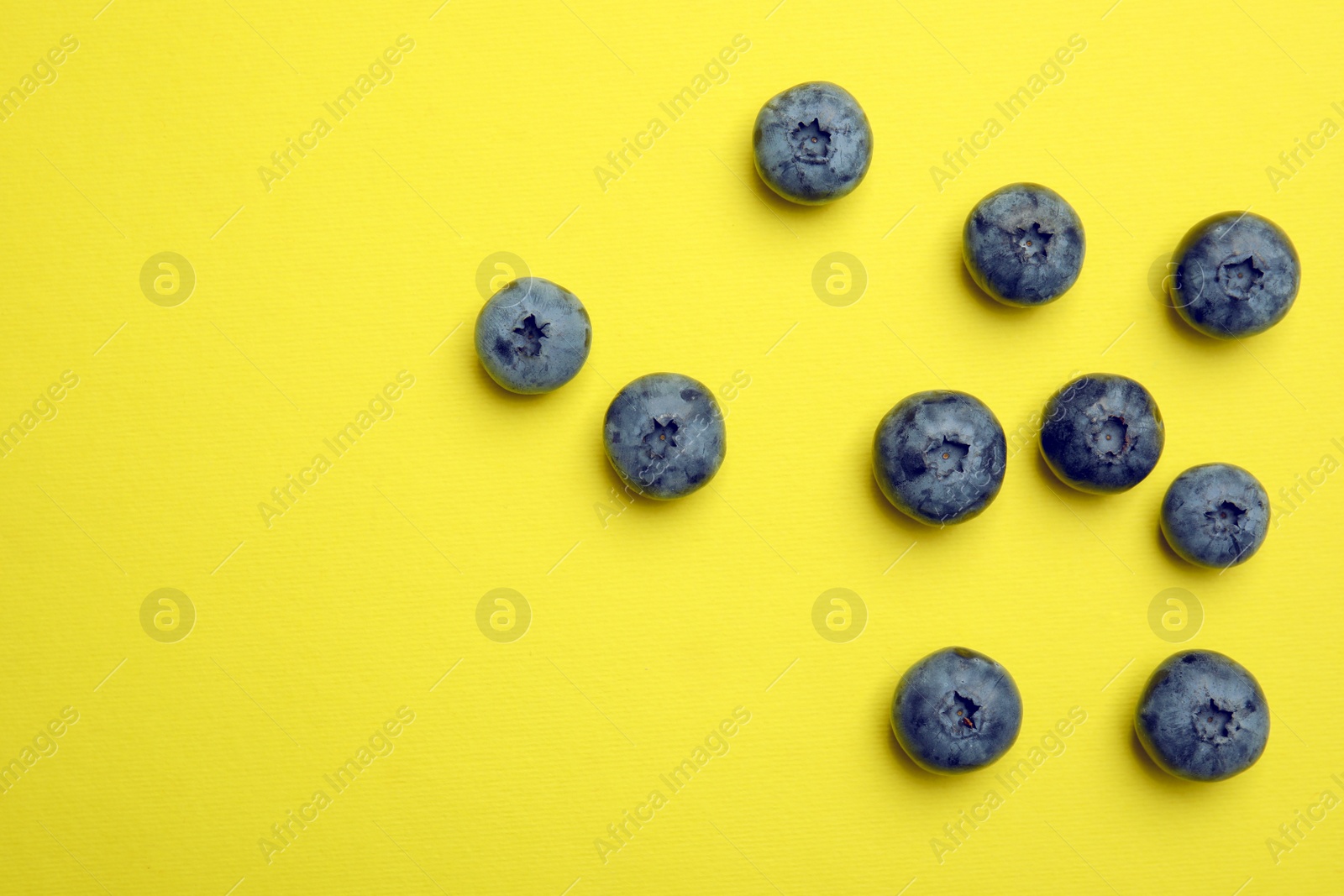 Photo of Flat lay composition with tasty blueberry and space for text on color background