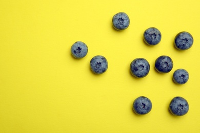 Photo of Flat lay composition with tasty blueberry and space for text on color background