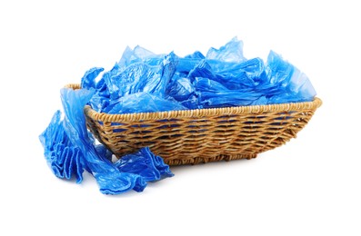 Basket with blue medical shoe covers isolated on white